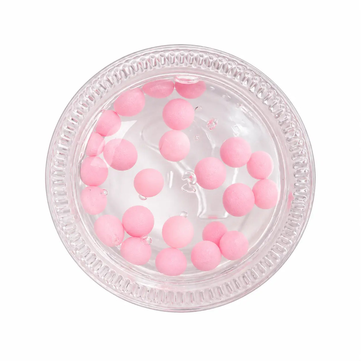 A top-down view of a clear plastic round container filled with small pink foam balls, isolated on a white background.