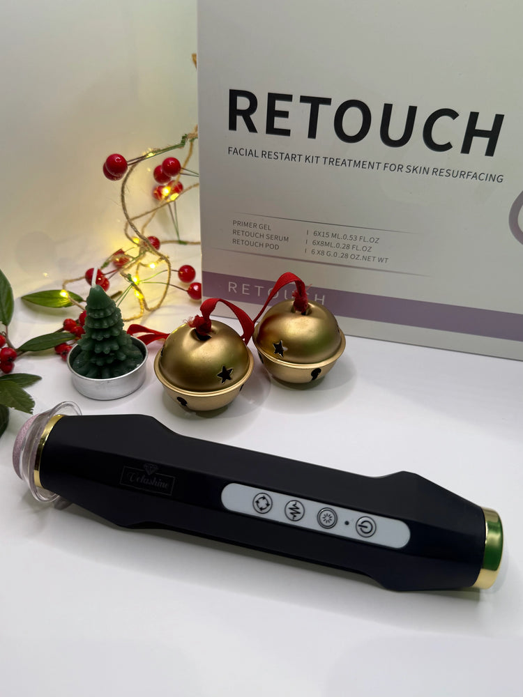 Facial rejuvenation device with 'Retouch' packaging and decorative items on a white surface.