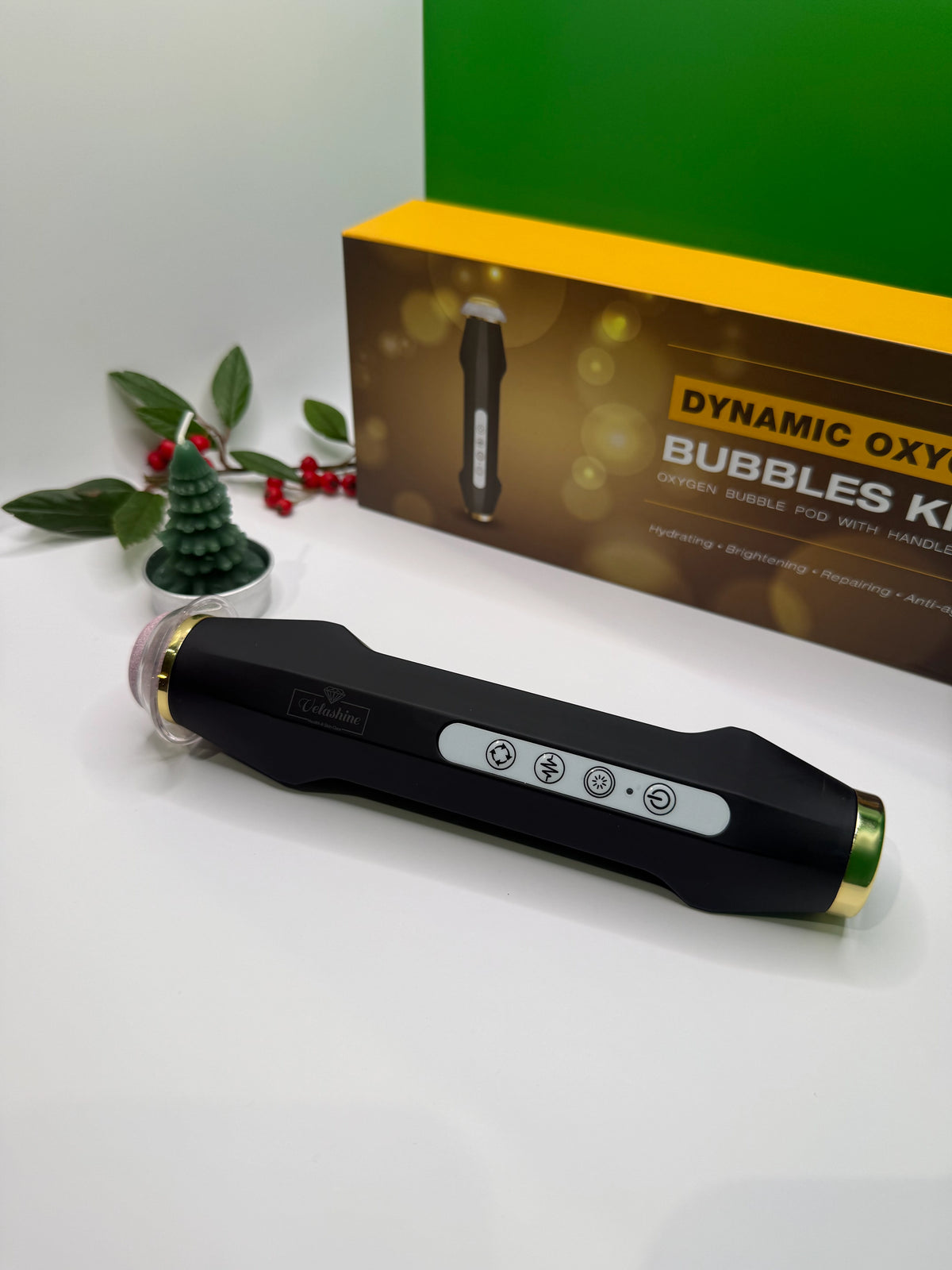 Black handheld device with control panel on a white surface, with a green box labeled 'Dynamic Oxygen Bubbles Kits' in the background.