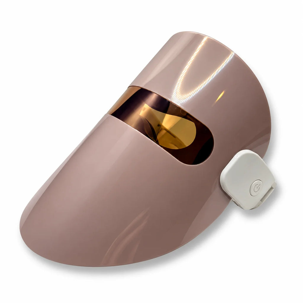 Beige LED light therapy face mask with rose gold visor and side power control