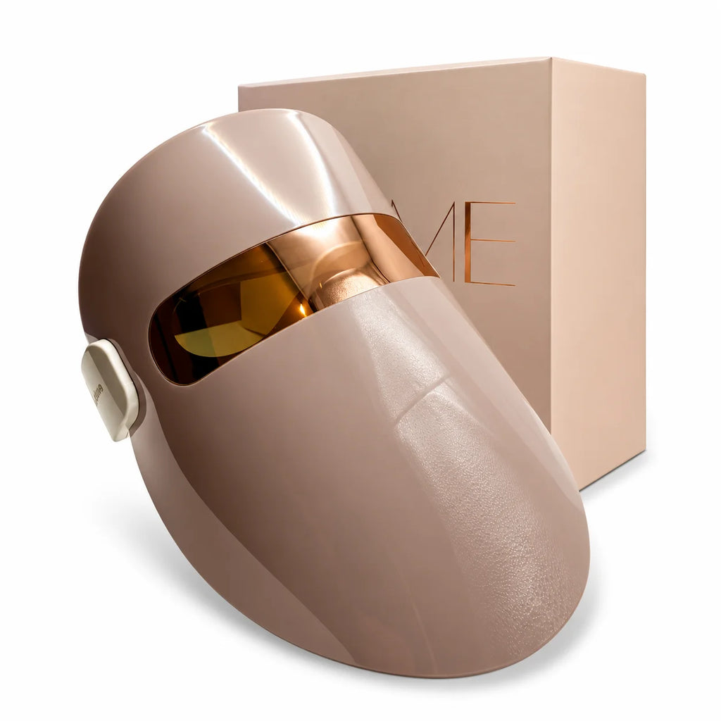 Beige LED light therapy face mask with rose gold visor displayed with product packaging