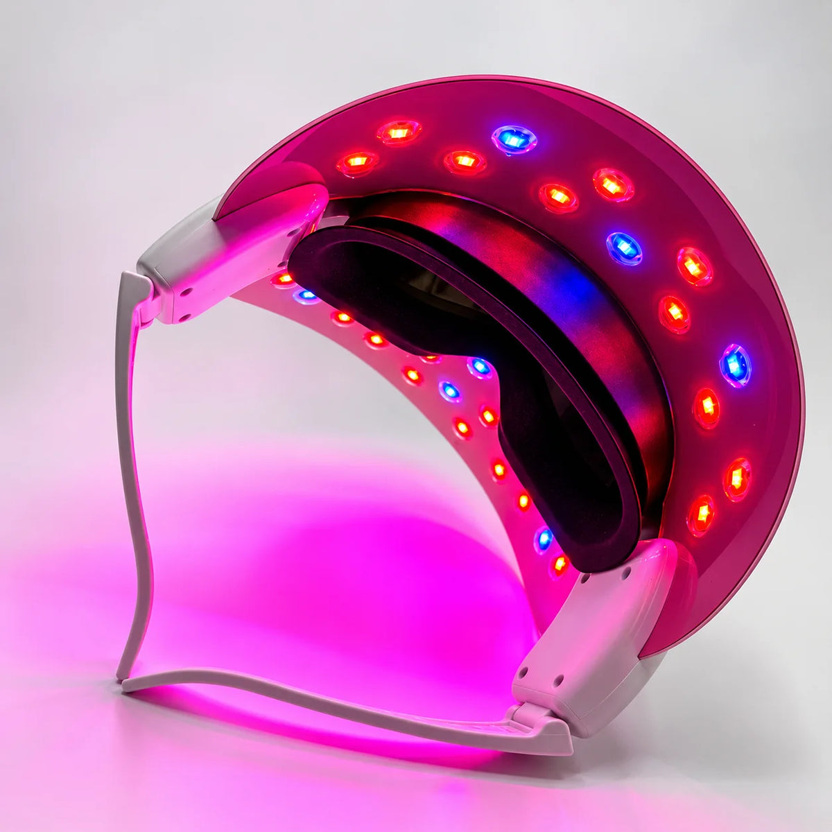 Interior of LED face mask illuminated with red and blue light therapy LEDs