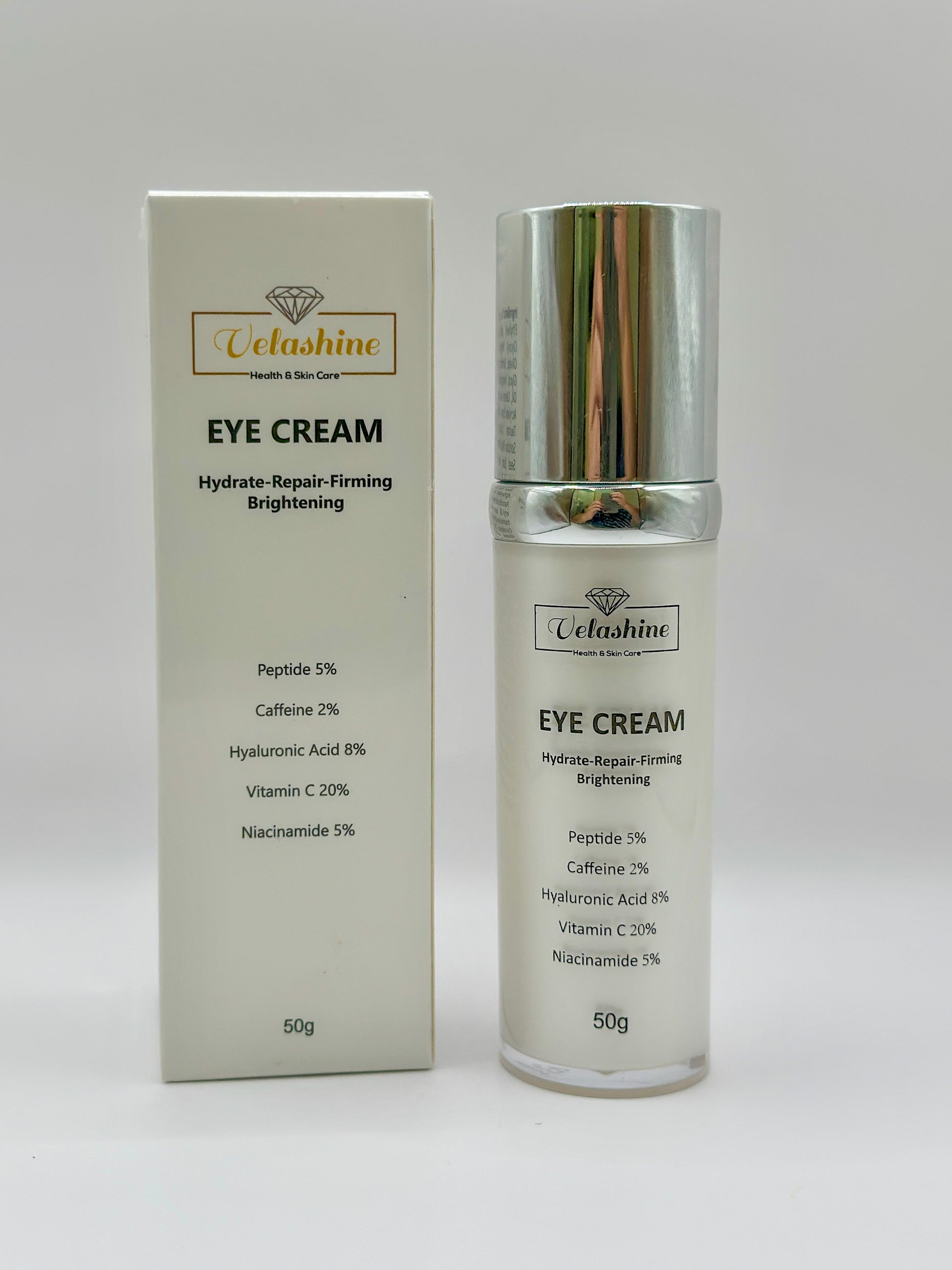 Velashine Eye Cream 50g bottle with chrome cap placed beside its retail box, labeled with benefits like hydrate, repair, firming, and brightening, and key ingredients such as peptide, caffeine, hyaluronic acid, vitamin C, and niacinamide.