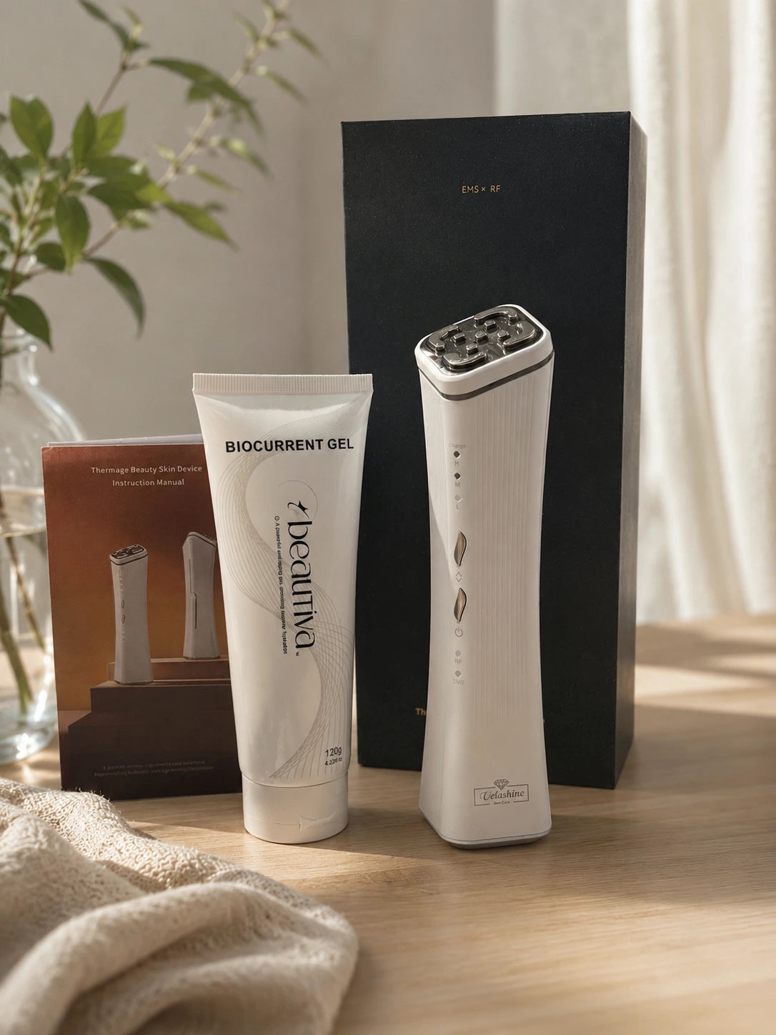 Beauty device and gel tube on a wooden surface with a plant in the background