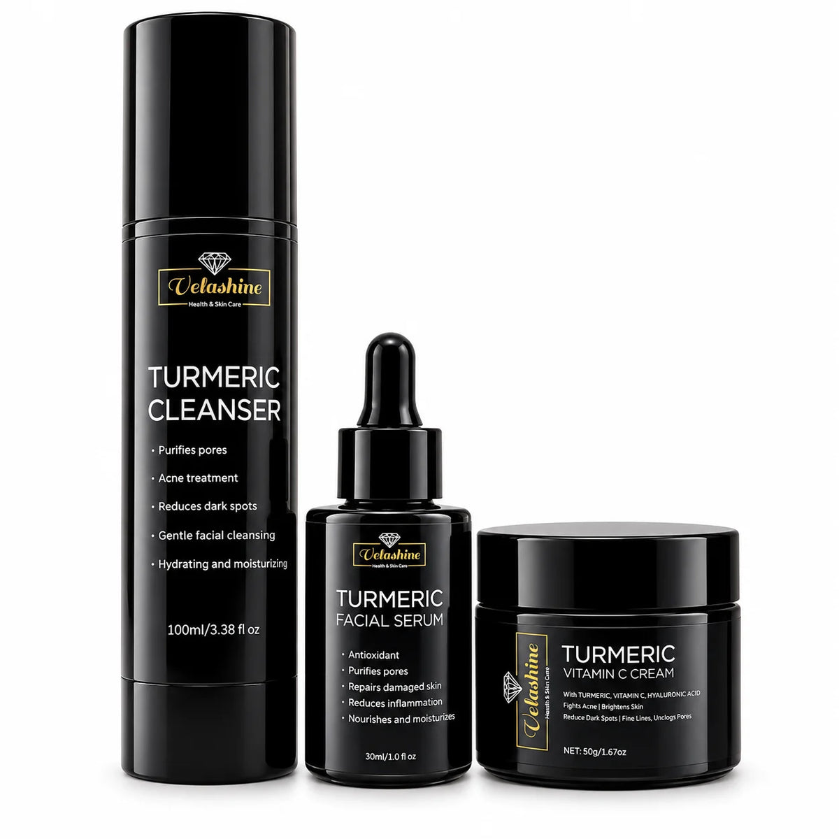 A three-piece skincare set by Velashine in matte black packaging, including a Turmeric Cleanser pump bottle, a Turmeric Facial Serum dropper bottle, and a Turmeric Vitamin C Cream jar, displayed on a clean white background.