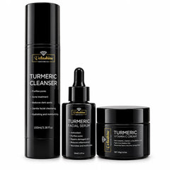 A three-piece skincare set by Velashine in matte black packaging, including a Turmeric Cleanser pump bottle, a Turmeric Facial Serum dropper bottle, and a Turmeric Vitamin C Cream jar, displayed on a clean white background.
